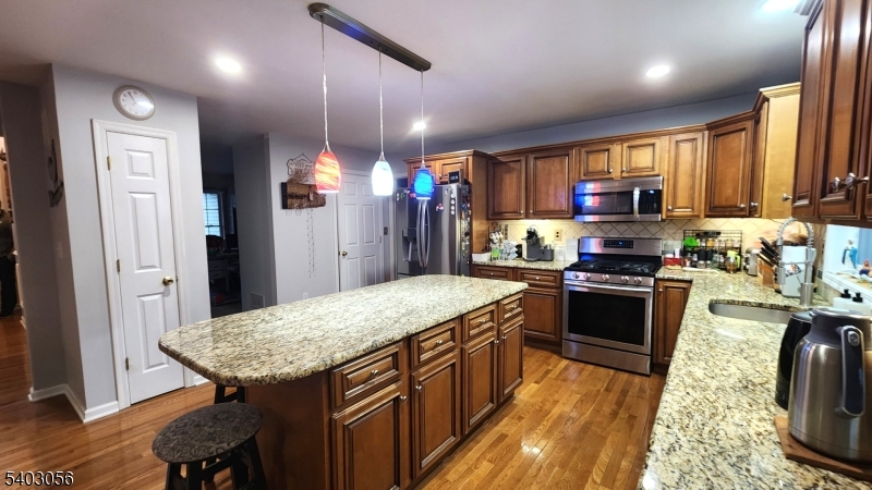52 Fox Hollow Road Montague, NJ 07827 - Photo 15 of 45 a kitchen with stainless steel appliances granite countertop a stove refrigerator and a wooden cabinets