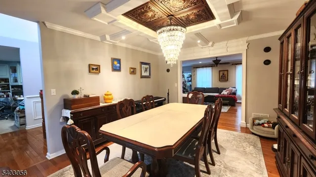 a view of a dining room with furniture and chandelier
