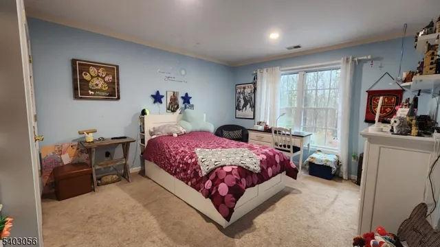 a bedroom with a bed dresser and a flat screen tv
