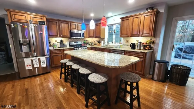 a kitchen with granite countertop a sink stove and cabinets