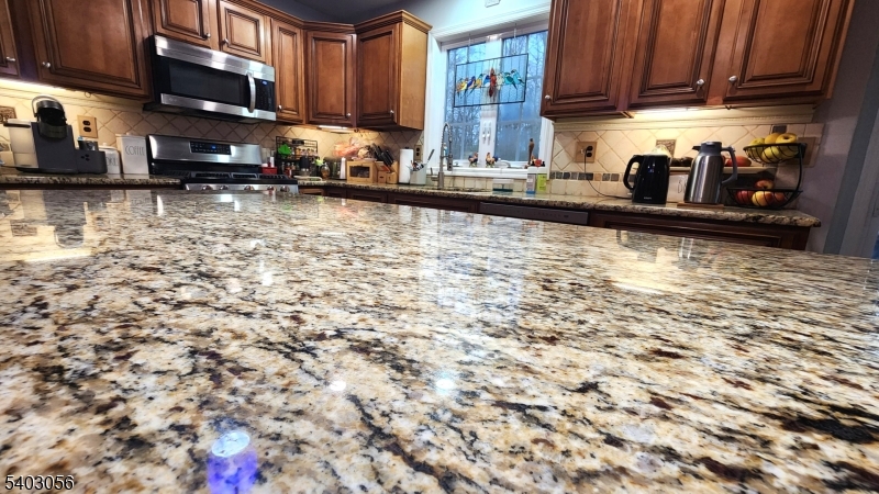 52 Fox Hollow Road Montague, NJ 07827 - Photo 9 of 45 a kitchen with granite countertop a sink stove and cabinets