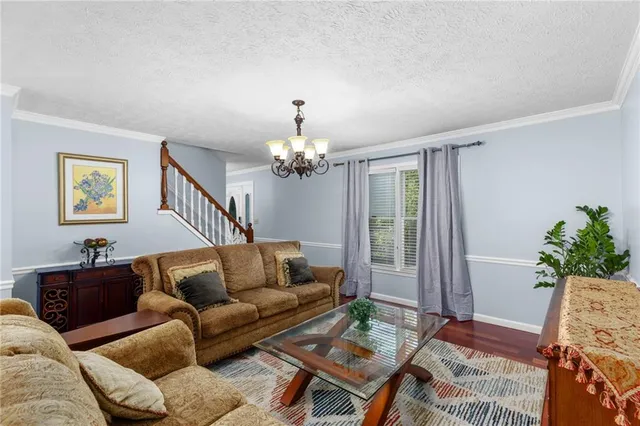 a kitchen with stainless steel appliances granite countertop a refrigerator a stove and a sink with granite countertops