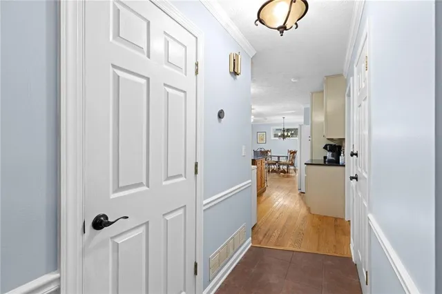 a dining room with furniture a chandelier and wooden floor