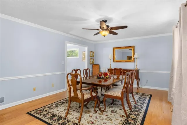 a bedroom with a large bed and a ceiling fan
