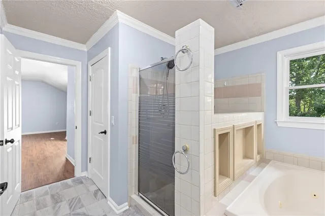 an aerial view of a house with outdoor space and trees all around