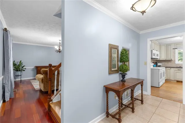 a living room with furniture a chandelier and a dining table