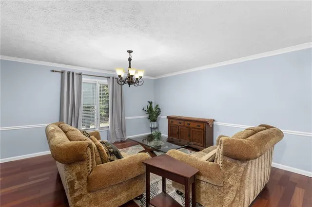 a kitchen with stainless steel appliances granite countertop a stove a sink and white cabinets