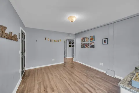 a kitchen with kitchen island granite countertop a sink appliances cabinets and a counter top space