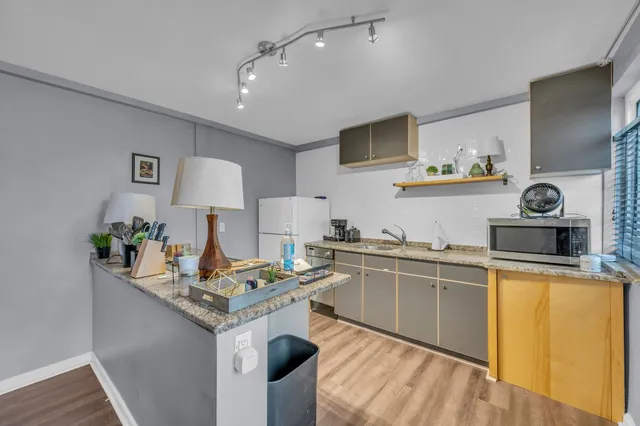 a kitchen with a sink stove and refrigerator