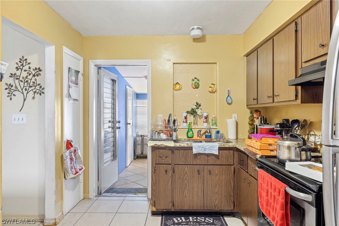 16 Massachusetts Road Lehigh Acres, FL 33936 - Photo 11 of 20 a kitchen with a sink stove and cabinets