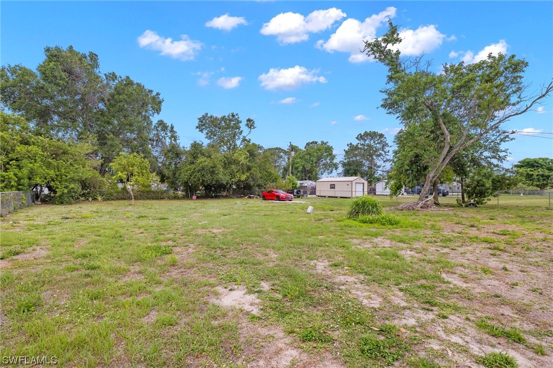 16 Massachusetts Road Lehigh Acres, FL 33936 - Photo 3 of 20 a yellow building with trees in the background