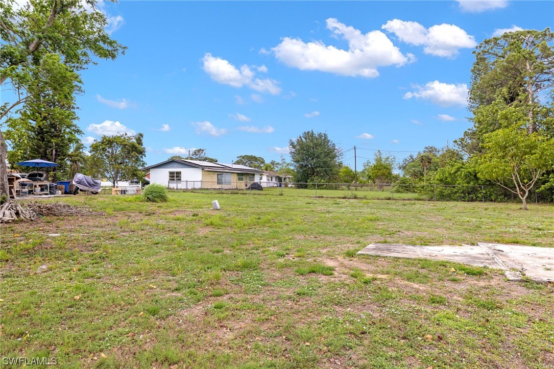 16 Massachusetts Road Lehigh Acres, FL 33936 - Photo 5 of 20 a view of a lake with a yard