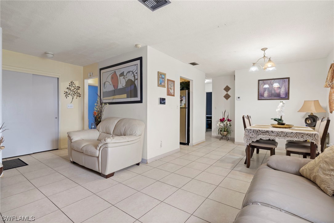 16 Massachusetts Road Lehigh Acres, FL 33936 - Photo 6 of 20 a living room with furniture and a work place area