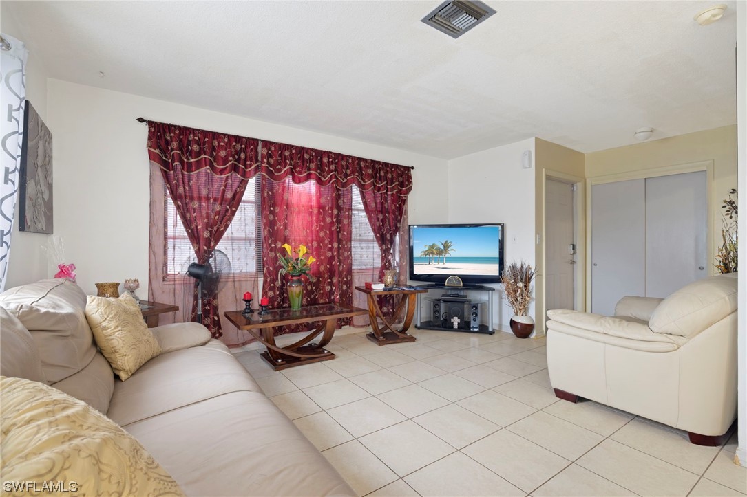 16 Massachusetts Road Lehigh Acres, FL 33936 - Photo 7 of 20 a living room with furniture a couch and a window