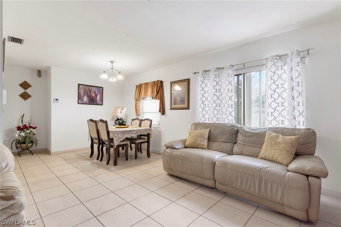 16 Massachusetts Road Lehigh Acres, FL 33936 - Photo 8 of 20 a living room with furniture and a large window