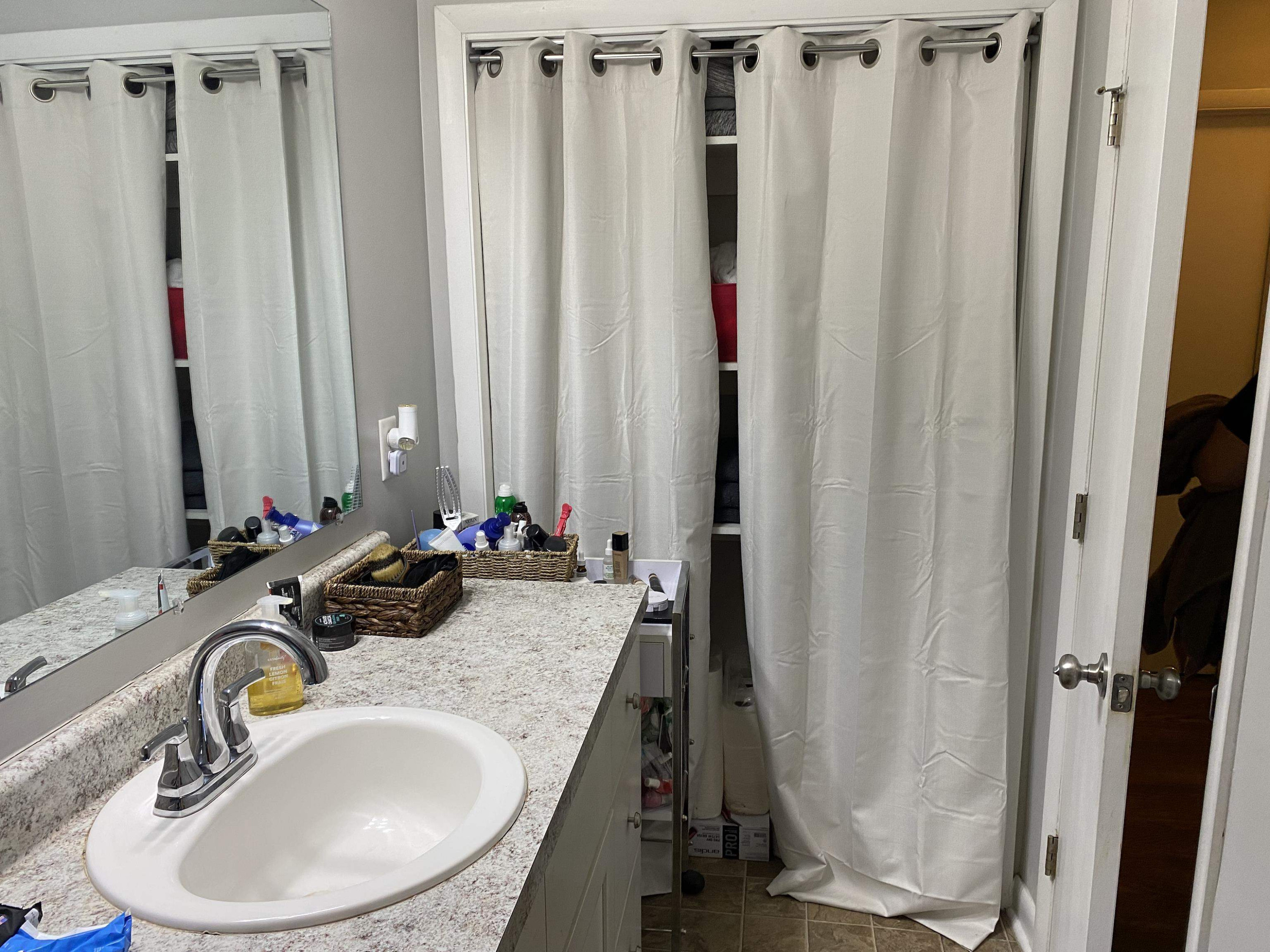 1613 Honeysuckle Road Raleigh, NC 27609 - Photo 12 of 24 a bathroom with sink a mirror a and toilet