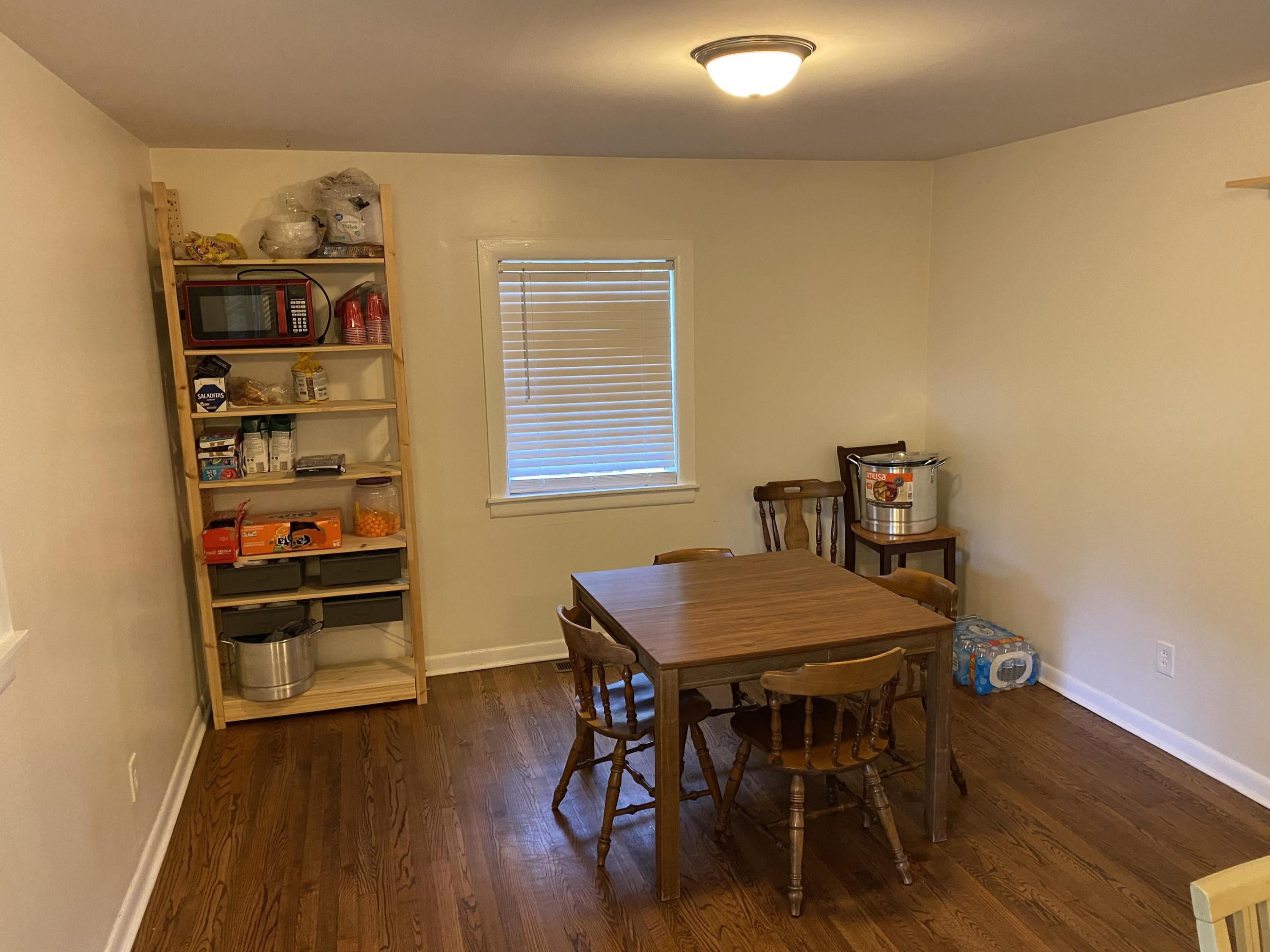 1613 Honeysuckle Road Raleigh, NC 27609 - Photo 16 of 24 a view of a dining room with furniture and wooden floor