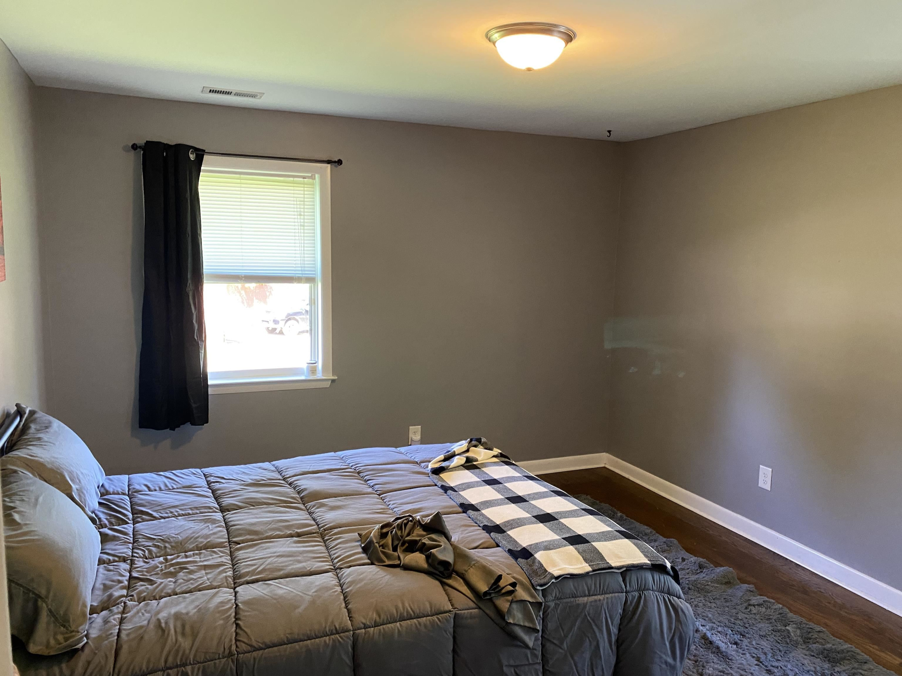 1613 Honeysuckle Road Raleigh, NC 27609 - Photo 8 of 24 a bedroom with a bed and a window