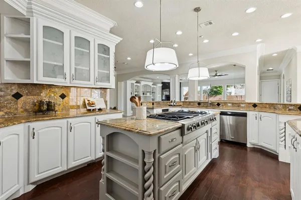 a kitchen with stainless steel appliances granite countertop a stove and a sink