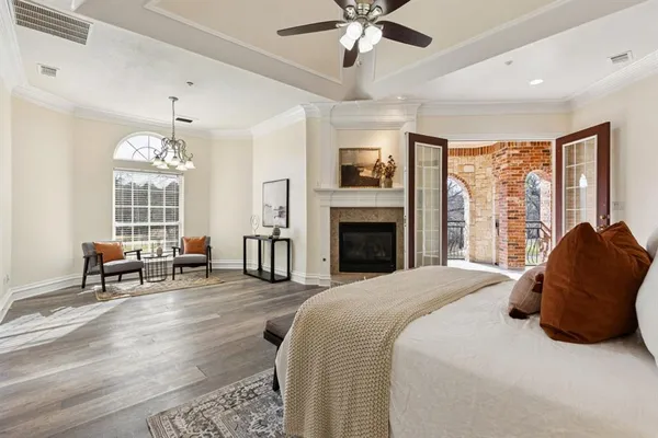 a bedroom with a bed and a chandelier