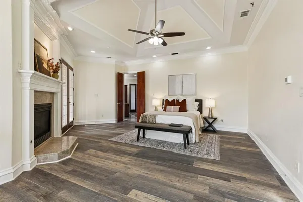 a living room with furniture a fireplace and a ceiling fan