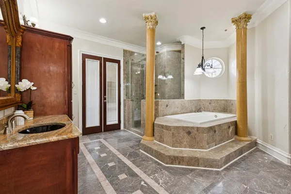 a bathroom with a sink a toilet a mirror and shower