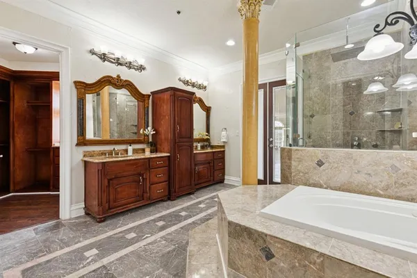 a spacious bathroom with a tub shower and sink