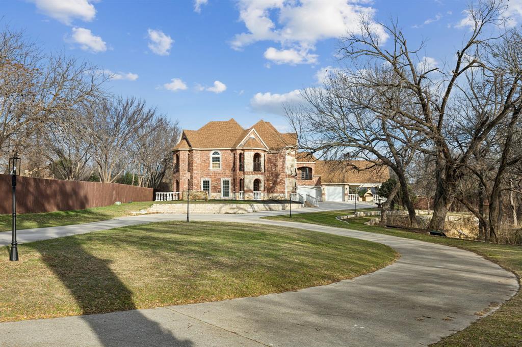 469 Apache Trail Keller, TX 76248 - Photo 4 of 39 a view of a white house with a big yard and large trees
