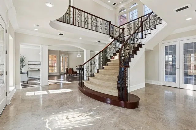 a kitchen with stainless steel appliances granite countertop a stove top oven a sink dishwasher and a refrigerator with wooden floor