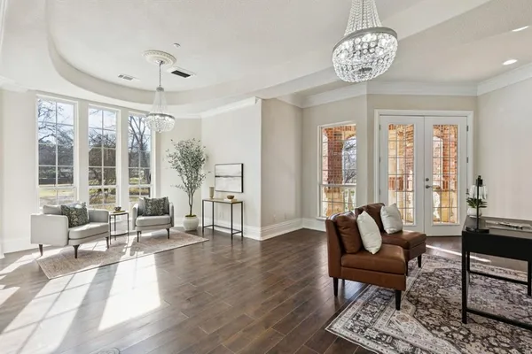 a view of a livingroom with furniture wooden floor and a chandelier