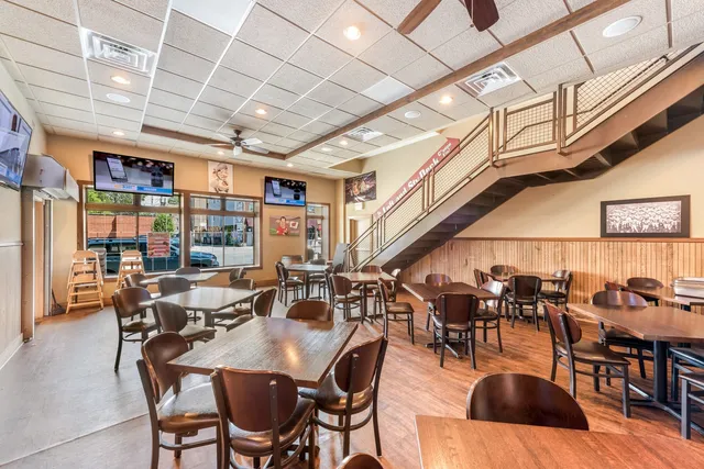 a view of a dining room with lots of furniture and wooden floor