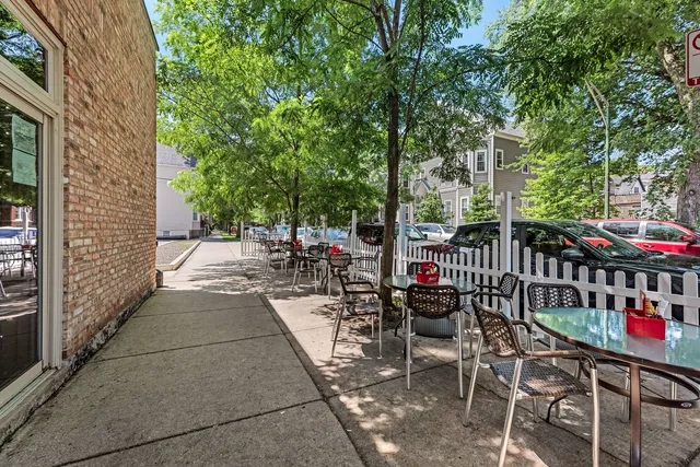 a view of a patio with table and chairs and potted plants