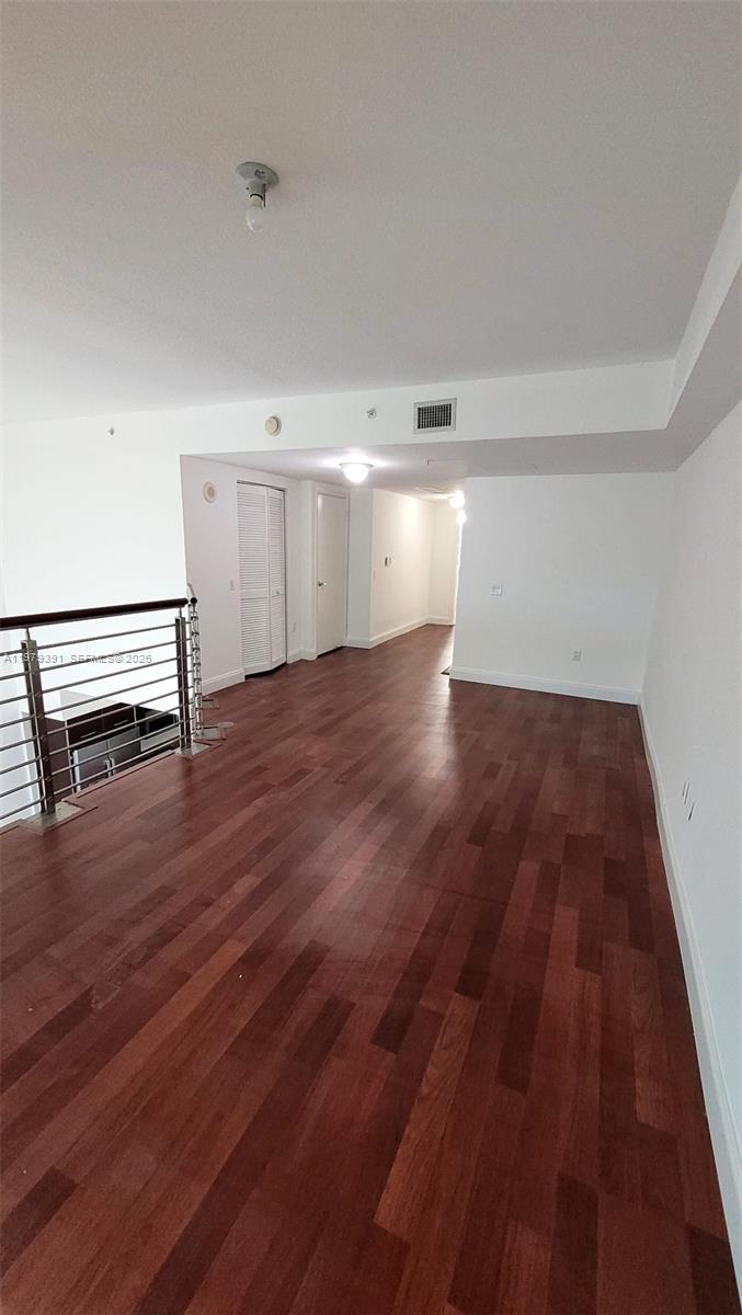 41 Southeast 5th Street, Unit 709 Miami, FL 33131 - Photo 14 of 17 a view of empty room with wooden floor