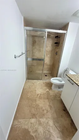 a bathroom with a shower and a toilet