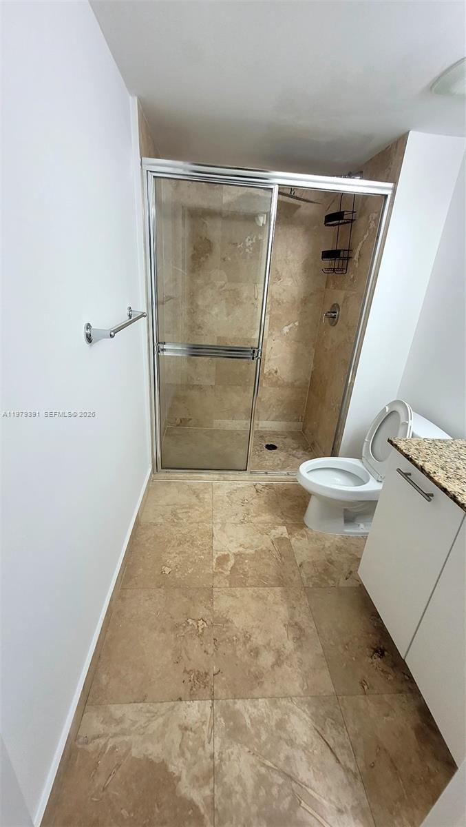 41 Southeast 5th Street, Unit 709 Miami, FL 33131 - Photo 15 of 17 a bathroom with a shower and a toilet