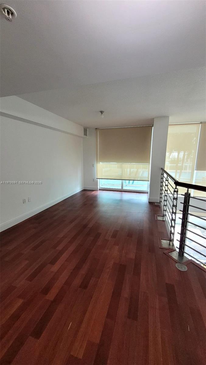 41 Southeast 5th Street, Unit 709 Miami, FL 33131 - Photo 4 of 17 wooden floor in an empty room with a window