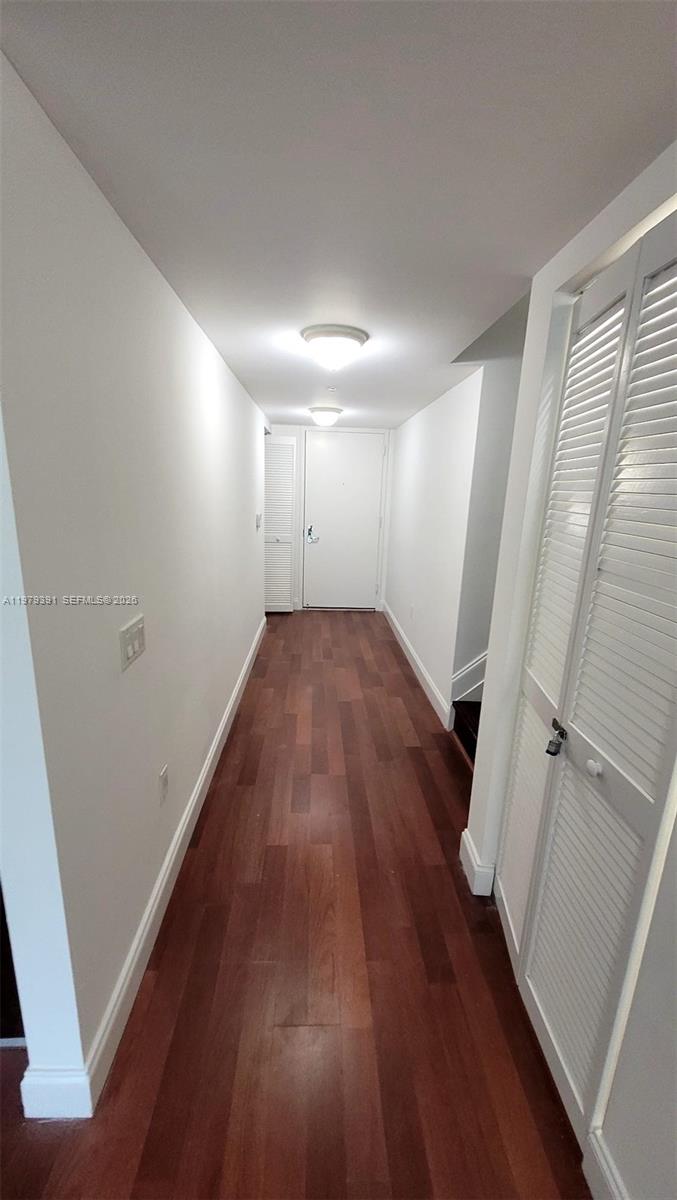 41 Southeast 5th Street, Unit 709 Miami, FL 33131 - Photo 6 of 17 wooden floor in an empty room with a window