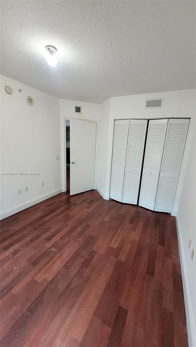 41 Southeast 5th Street, Unit 709 Miami, FL 33131 - Photo 7 of 17 wooden floor in an empty room