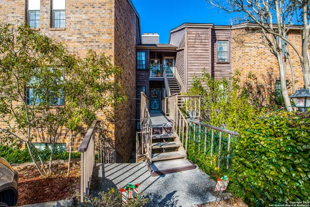 a view of a house with a small yard and plants