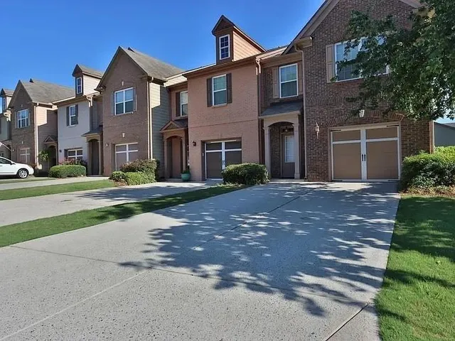 a front view of a building with a garden
