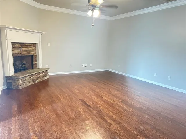 wooden floor in an empty room with a fireplace