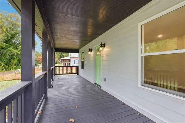 a view of a porch with wooden floor and windows