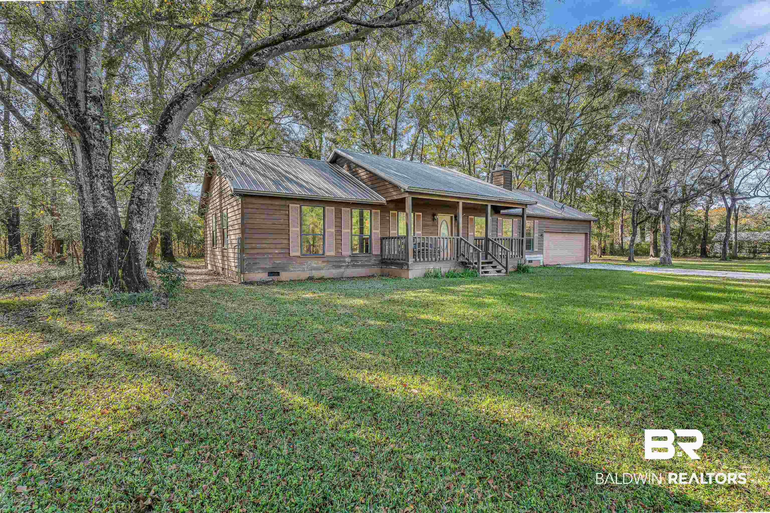 7787 Bellingrath Road Theodore, AL 36582 - Photo 1 of 36 View of front of house with crawl space, covered porch, a front yard, a chimney, and a metal roof