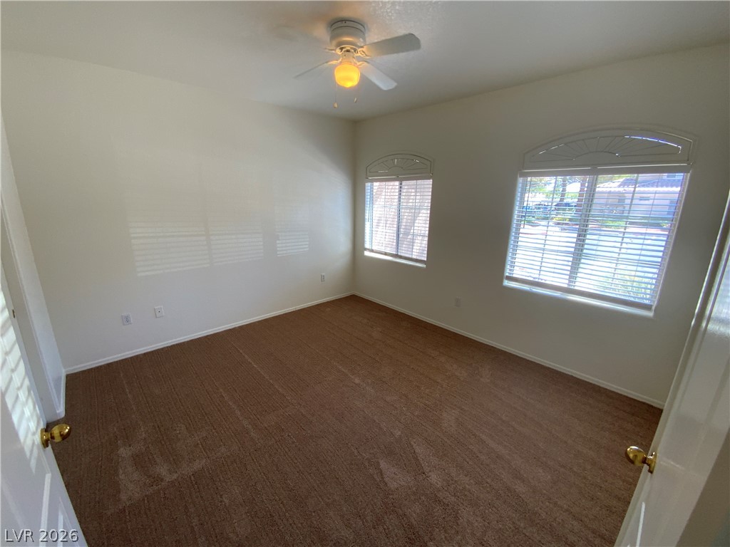 7400 West Flamingo Road, Unit 1039 Las Vegas, NV 89147 - Photo 14 of 40 A well-lit bedroom with two generous windows and a ceiling fan for comfort.