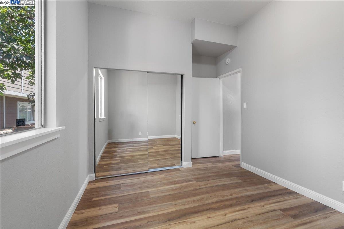 3214 13th Avenue Oakland, CA 94610 - Photo 11 of 51 a view of empty room with wooden floor and fan