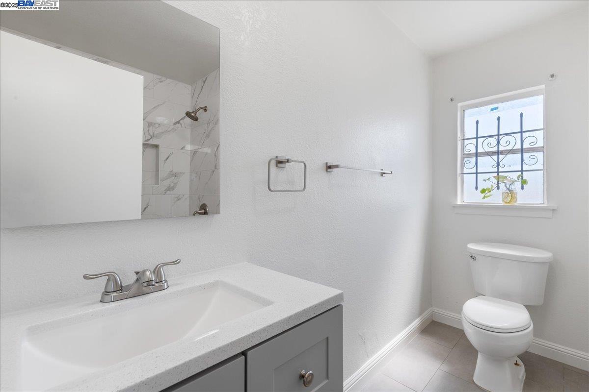 3214 13th Avenue Oakland, CA 94610 - Photo 13 of 51 a bathroom with a sink toilet and a mirror