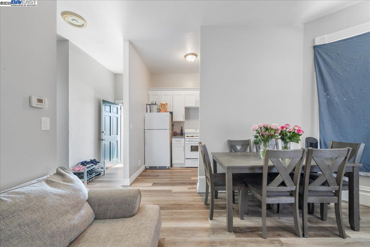 3214 13th Avenue Oakland, CA 94610 - Photo 17 of 51 a living room with furniture a dining table and a potted plant