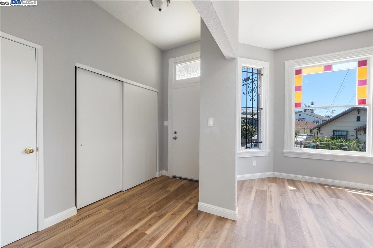 3214 13th Avenue Oakland, CA 94610 - Photo 30 of 51 an empty room with wooden floor and windows