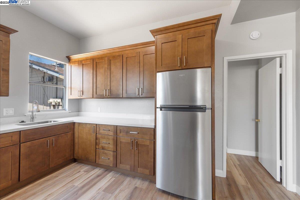 3214 13th Avenue Oakland, CA 94610 - Photo 32 of 51 a kitchen with a refrigerator sink and cabinets