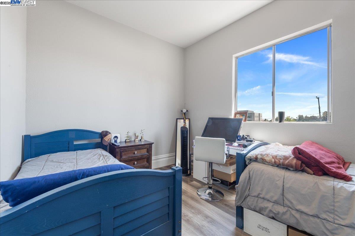 3214 13th Avenue Oakland, CA 94610 - Photo 41 of 51 a bedroom with a bed and two windows